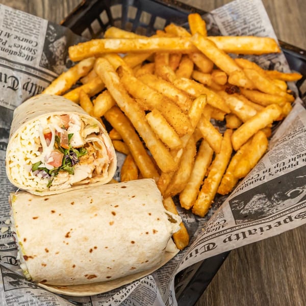 Two Crooked Tale Gastropub wraps with chicken, cheese, and vegetables, served with a side of fries.